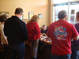 Concentrating on signing the book just right!