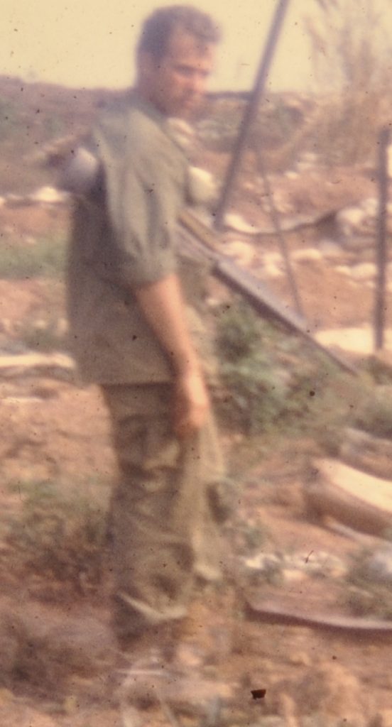 A blurry photo of 1st Lieutenant Dave Anson carrying his weapon at Lang Vei just before his unit is overrun in April 1969.