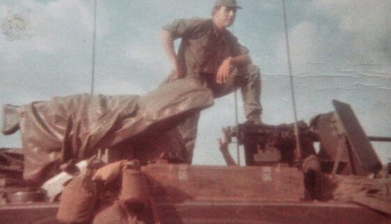 1st Lieutenant Dave Anson standing on top of an armored vehicle in Vietnam.