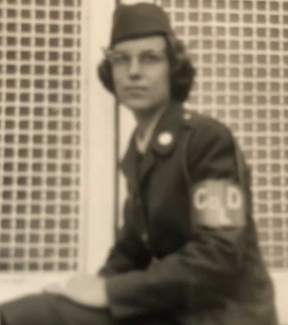 Image of Sue Hodge in uniform sitting on a bench.