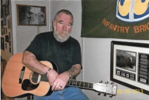 Jack with his guitar at home