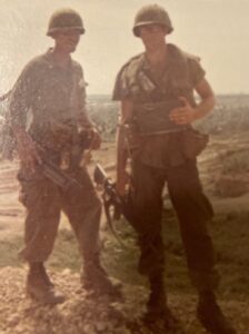 Color photo of Dave Himmer and another soldier in Vietnam