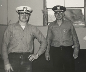 Gene (right) and friend trying on officers' covers