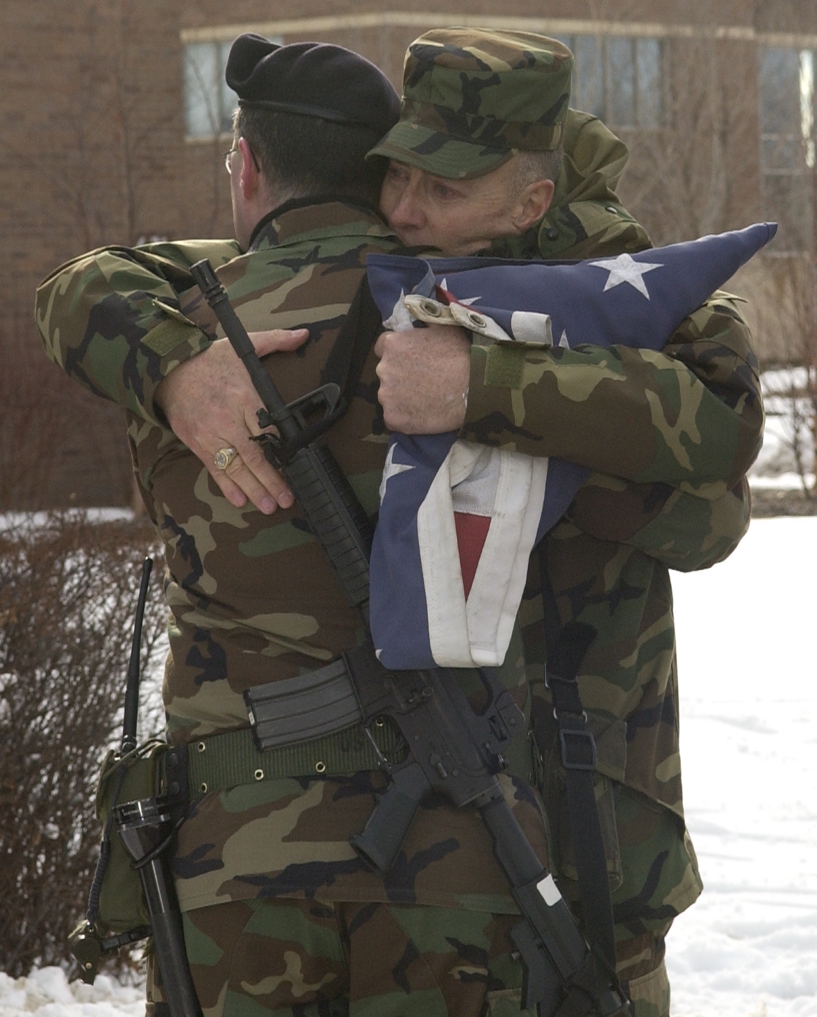 A military father hugging his sone