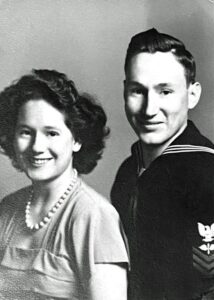 Sailor in uniform and woman smiling together