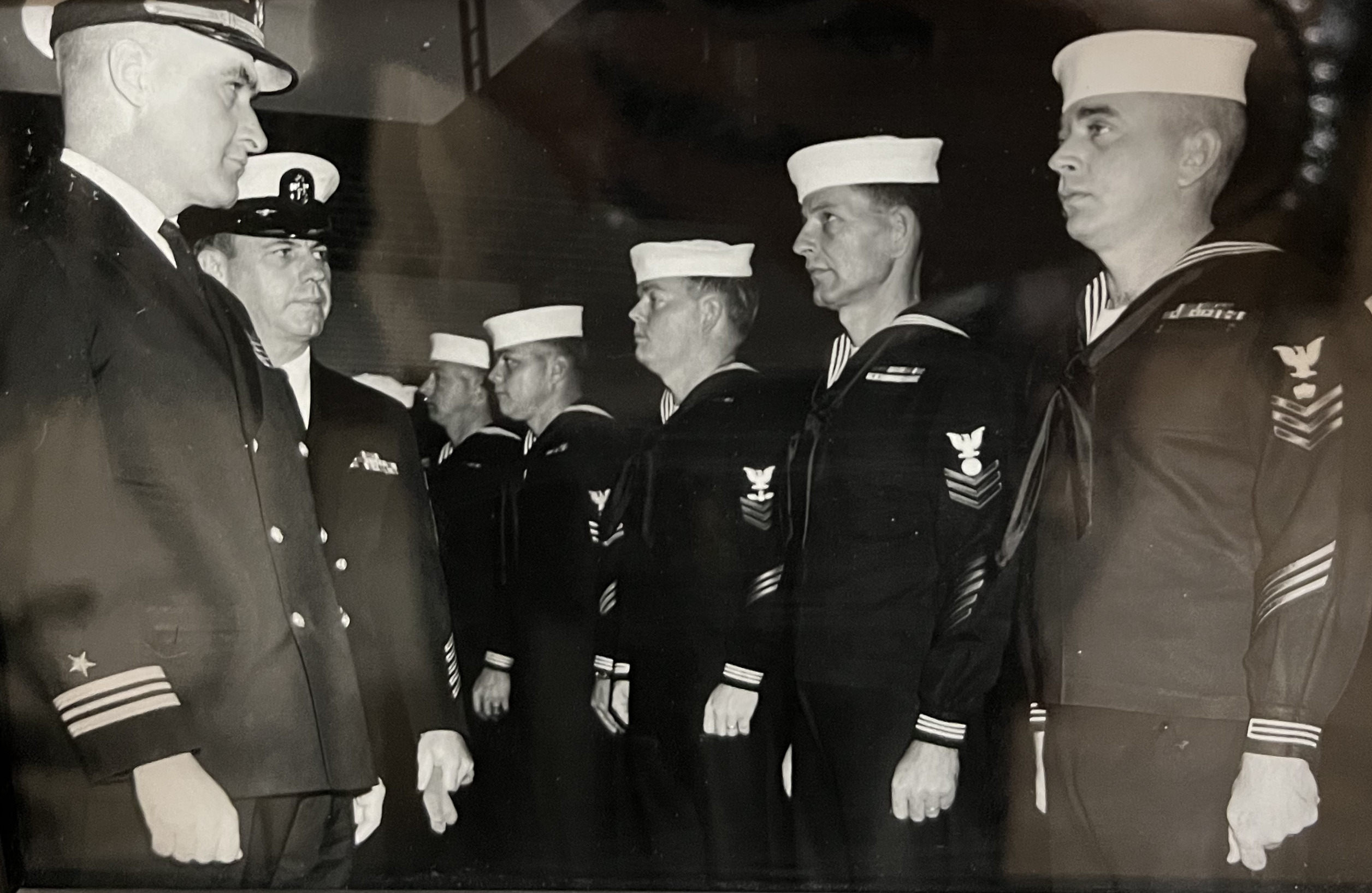 Navy Lieutenant Commander inspecting sailors