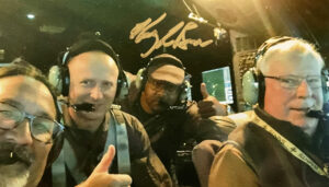 Four men in a C-130 flight simulator
