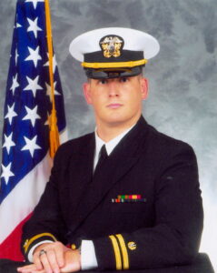 A male Navy lieutenant in his dress blue uniform