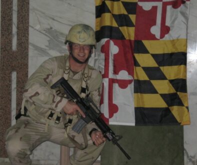 Tom in Iraq in 2005 with Maryland Flag
