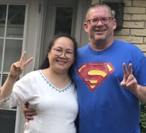 A man and a woman displaying peace signs.