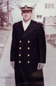 A Navy Officer Candidate in his winter uniform outside