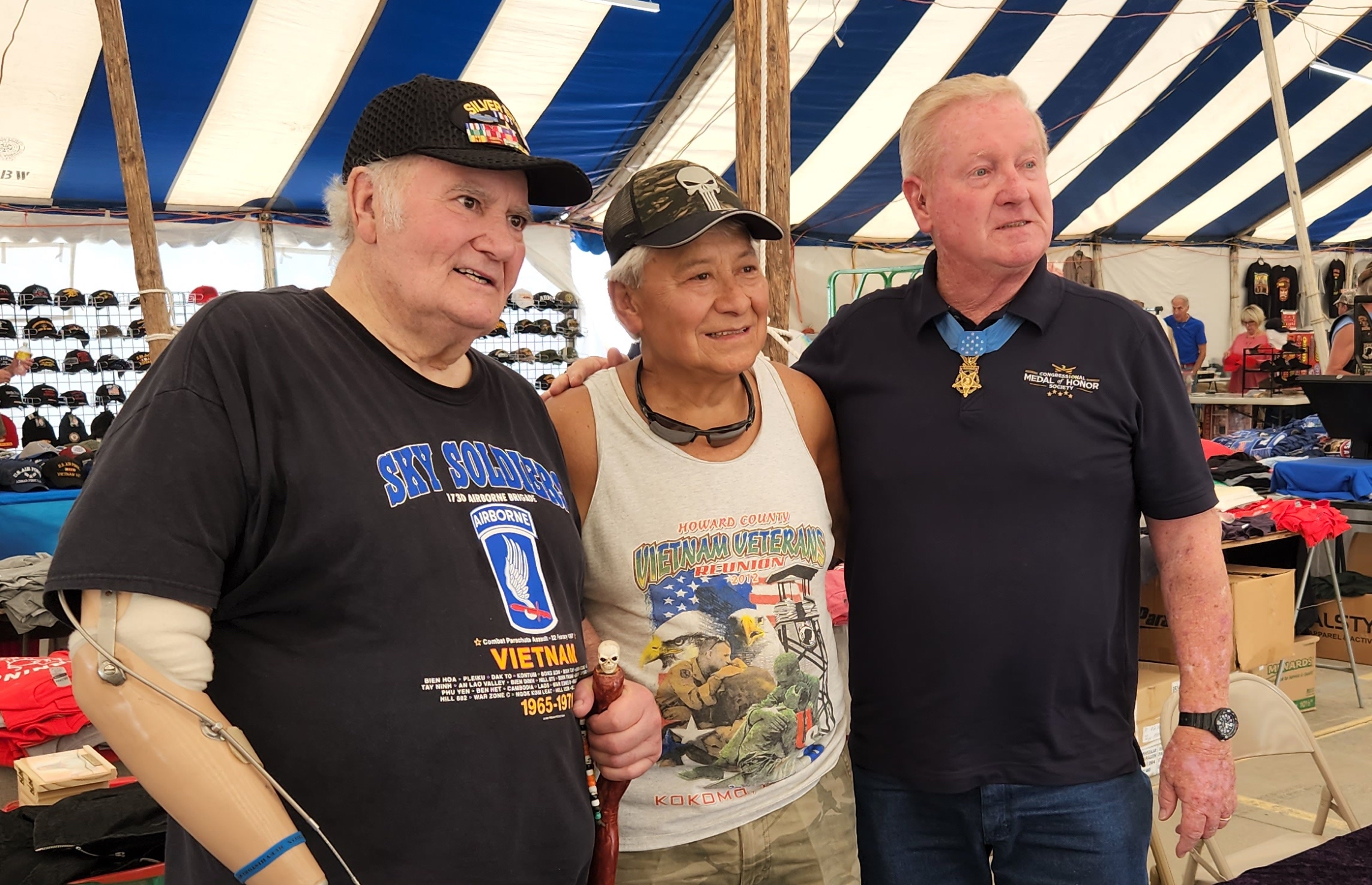 Two Vietnam veterans standing with a Medal of Honor recipient