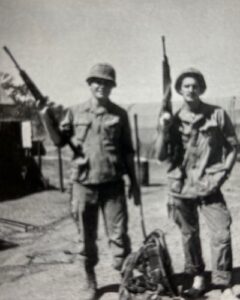 Two soldiers standing with their M16s in Vietnam
