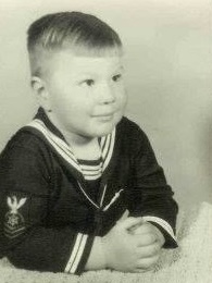 Two-year-old boy in a Navy sailors outfit