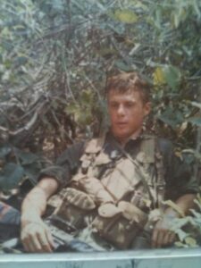 U.S. soldier in Vietnam laying back and relaxing in the tall grass in Vietnam