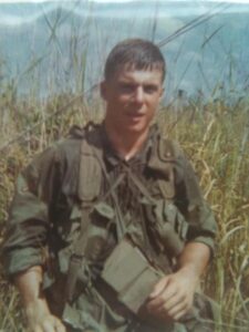 U.S. soldier in tall grass in Vietnam