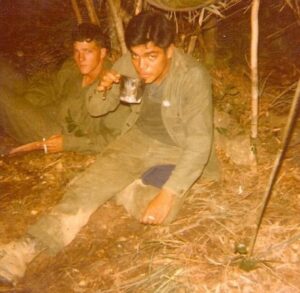 Two male U.S. Marines taking a break in the Philippine jungle