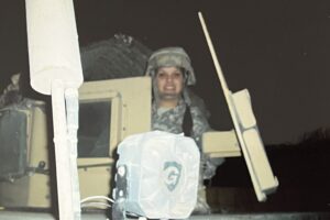 Female Army captain in uniform disembarking an armored vehicle