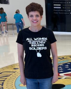 Woman standing and wearing a black t-shirt and jeans