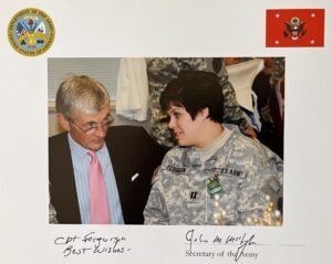 Man in suit talking to female Army captain in uniform