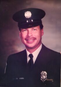 A man wearing his fire department dress uniform