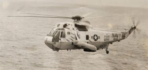 An SH-3 Sea King helicopter in flight over water