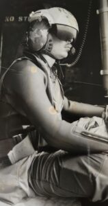 U.S. Navy rescue swimmer wearing a helmet and a wetsuit