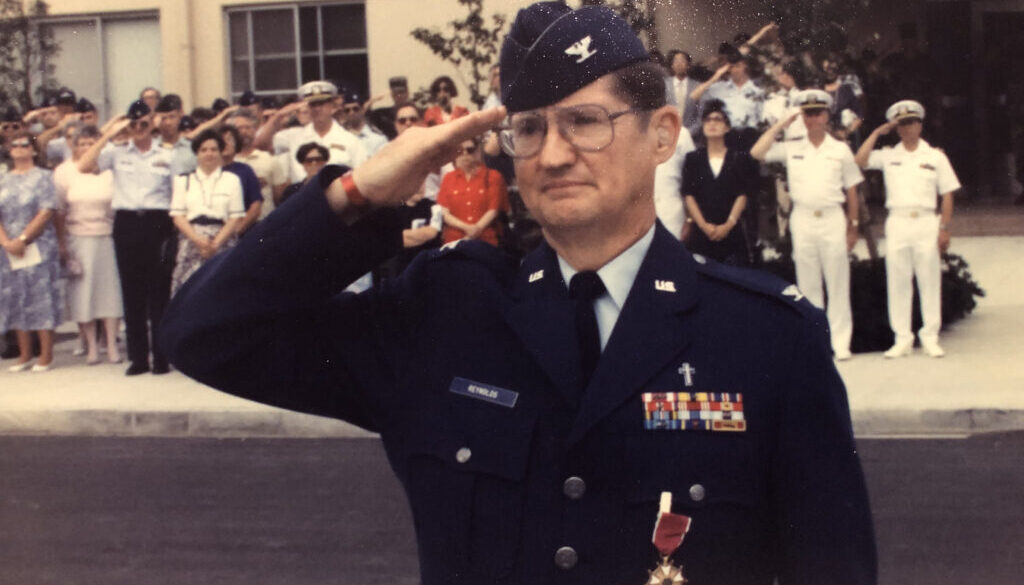 Chaplain, Colonel, Marion Reynolds, U.S. Air Force (Retired), saluting at his retirement ceremony