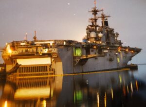 U.S. Navy amphibious ship tied up at a pier