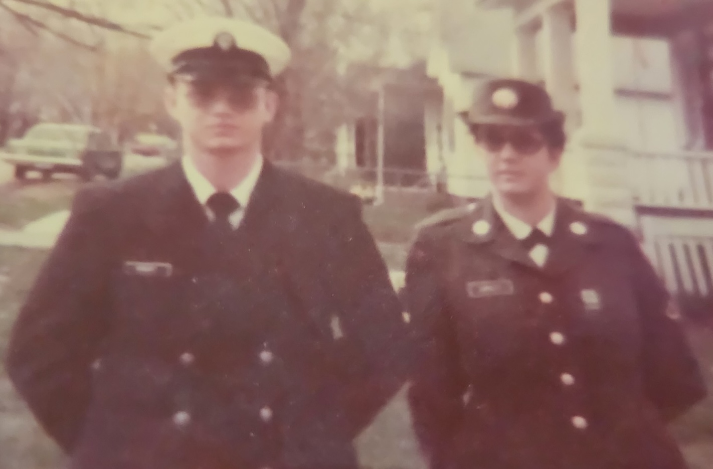 A brother in a Navy uniform and his sister in an Army uniform