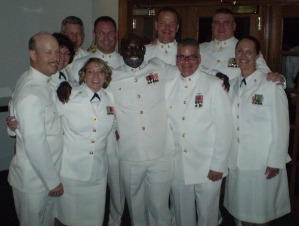 Group of male and female U.S. Navy chief petty officers in choker white uniforms