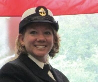 Female chief petty officer in dress blue uniform and cover