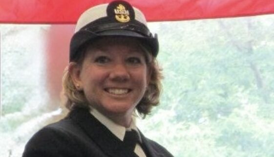 Female chief petty officer in dress blue uniform and cover