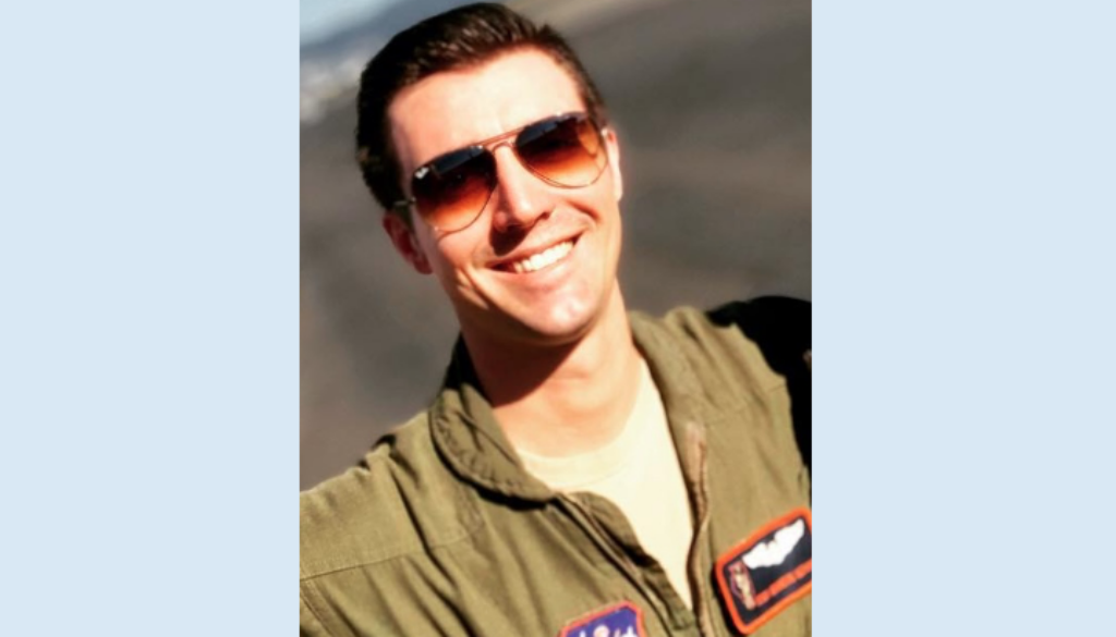 Male Air Force airman wearing sun glasses and a flight suit.