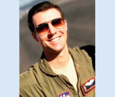 Male Air Force airman wearing sun glasses and a flight suit.