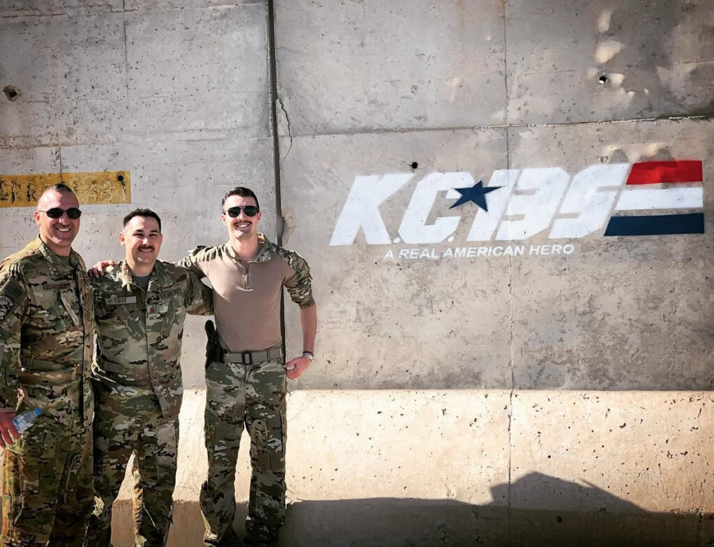 Brandon Merano (right) and two fellow KC-135 crewmembers on deployment