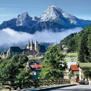 View of the Bavarian Alps with picturesque buildings in the foreground