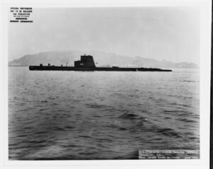 Photo of submarine with hull number 214 cruising in front of an island
